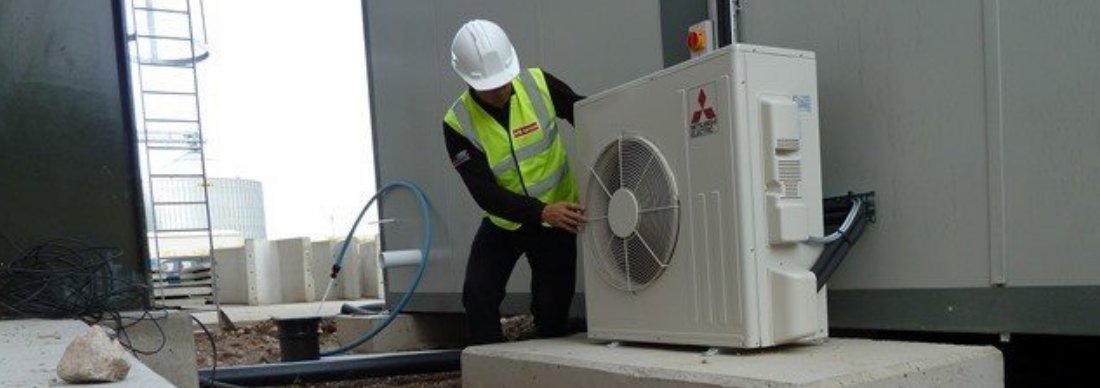 Andrew Bourner inspecting an industrial roof unit.